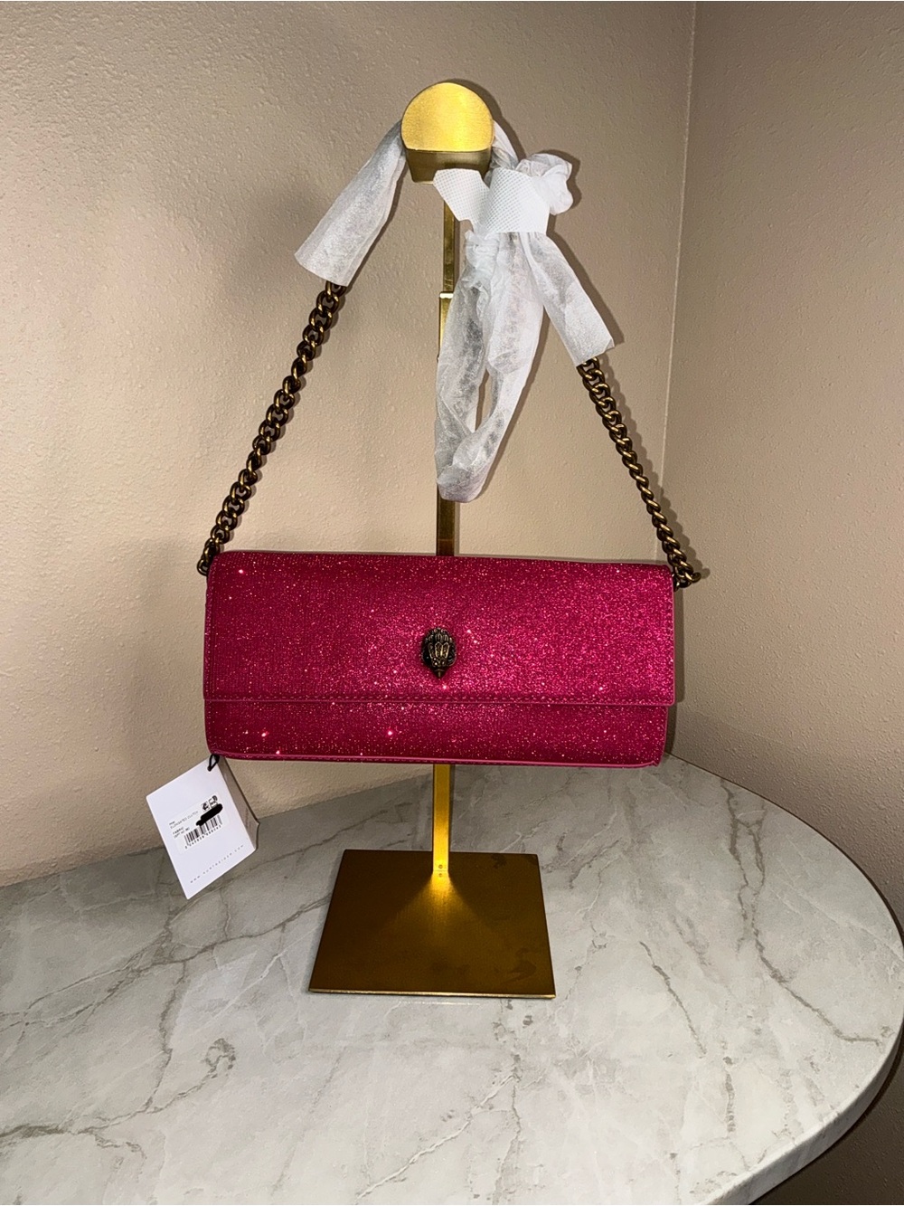 Kurt Geiger London elongated clutch vibrant pink glitter finish w/eagle head
